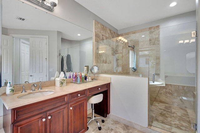 bathroom featuring a shower with door and vanity