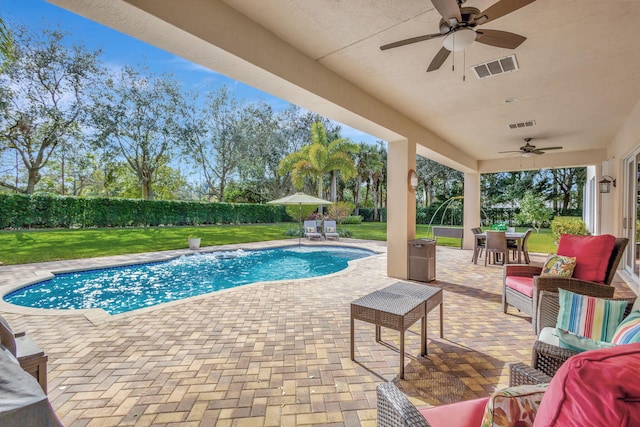 view of swimming pool featuring ceiling fan, a yard, an outdoor hangout area, and a patio area