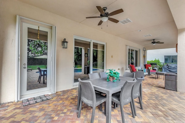 view of patio with outdoor lounge area and ceiling fan