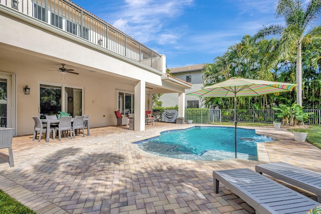 view of swimming pool featuring ceiling fan and a patio area