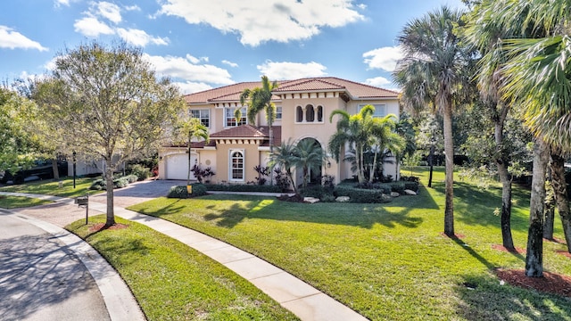 mediterranean / spanish home featuring a front yard