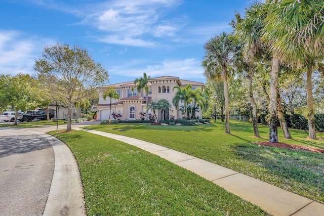 view of front facade featuring a garage and a front lawn