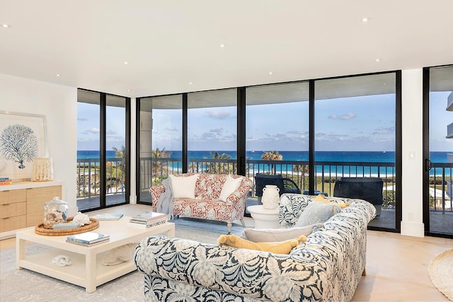 living room with a wall of windows and a water view