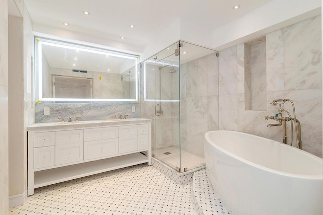 bathroom featuring vanity, shower with separate bathtub, and tile walls