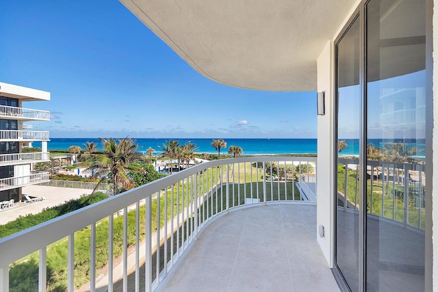 balcony featuring a water view and a view of the beach