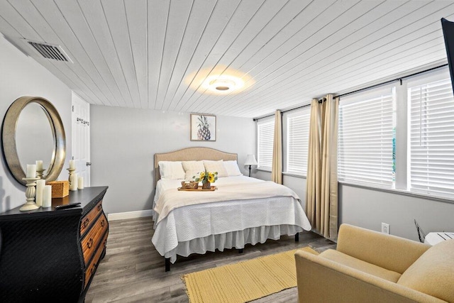 bedroom with wood ceiling and dark hardwood / wood-style floors