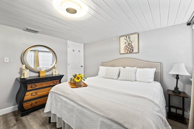 bedroom with wood ceiling and hardwood / wood-style flooring