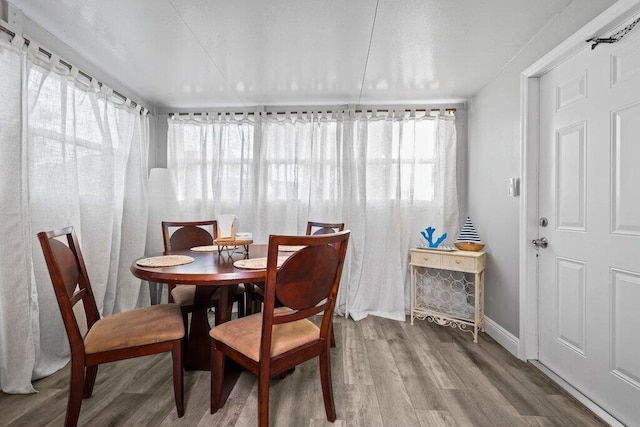 5219 NE 20th Ter, Pompano Beach, FL 33064 - dining area with wood finished floors, baseboards, and plenty of natural light