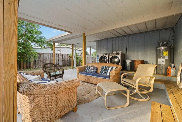 5219 NE 20th Ter, Pompano Beach, FL 33064 - view of patio featuring fence, washing machine and dryer, water heater, and an outdoor living space