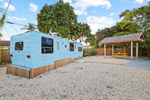 5219 NE 20th Ter, Pompano Beach, FL 33064 - view of side of home featuring fence, a gazebo, and a patio