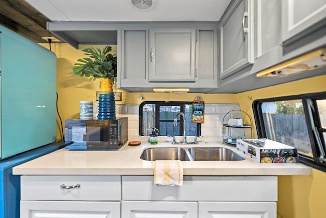 5219 NE 20th Ter, Pompano Beach, FL 33064 - kitchen featuring black microwave, gray cabinetry, and a sink