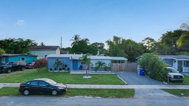 5219 NE 20th Ter, Pompano Beach, FL 33064 - ranch-style house featuring fence and a front lawn
