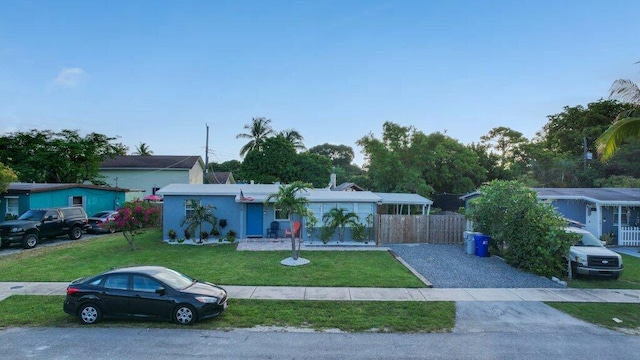 single story home featuring a front yard