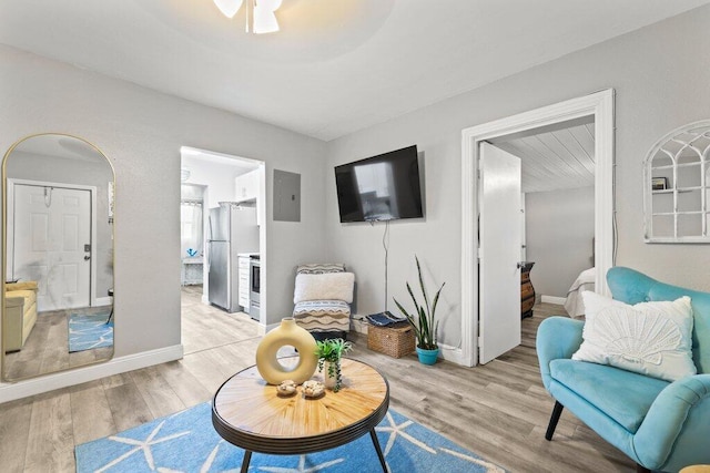 living area with light hardwood / wood-style flooring and electric panel