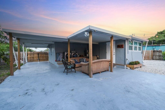 exterior space featuring washer / clothes dryer, a water view, and an outdoor hangout area