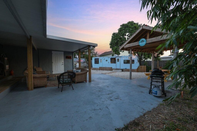 yard at dusk with outdoor lounge area and a patio