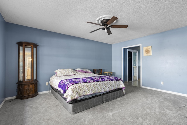 carpeted bedroom with a textured ceiling and ceiling fan