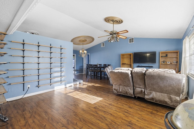 living room featuring lofted ceiling, dark wood-type flooring, and ceiling fan with notable chandelier