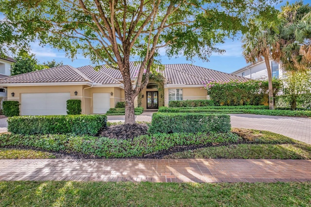 mediterranean / spanish-style home with a garage