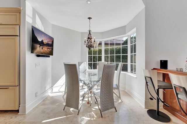 dining space featuring a notable chandelier