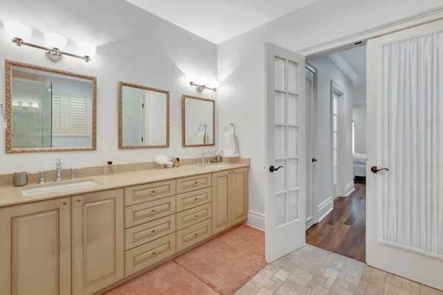 bathroom featuring hardwood / wood-style flooring, vanity, and ornamental molding