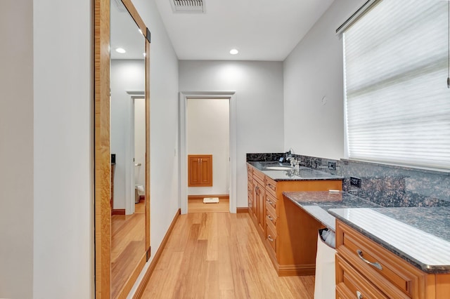 bathroom featuring toilet, vanity, and hardwood / wood-style flooring