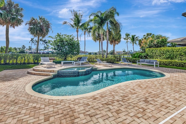 view of swimming pool featuring an in ground hot tub and a patio