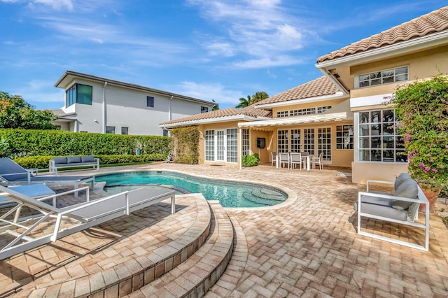 view of swimming pool featuring french doors and a patio