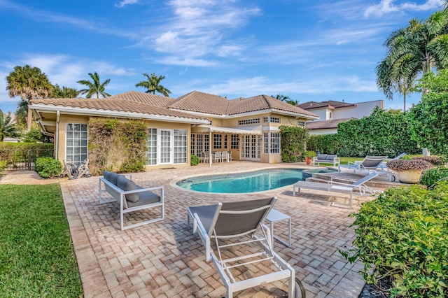 view of pool featuring french doors and a patio area