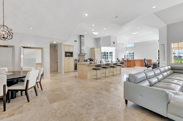 living room with high vaulted ceiling and an inviting chandelier