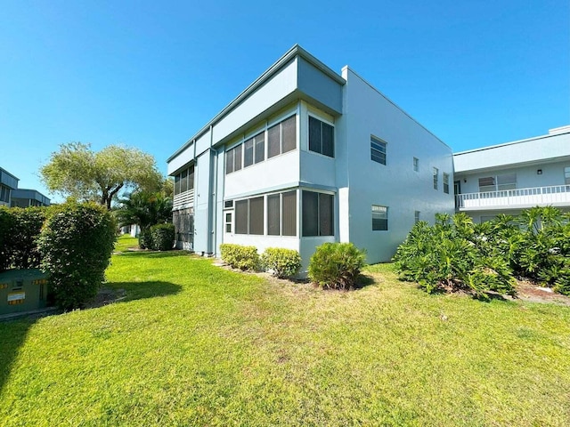 rear view of house featuring a yard