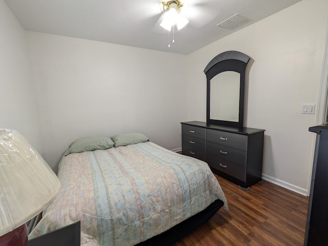 bedroom with dark hardwood / wood-style flooring