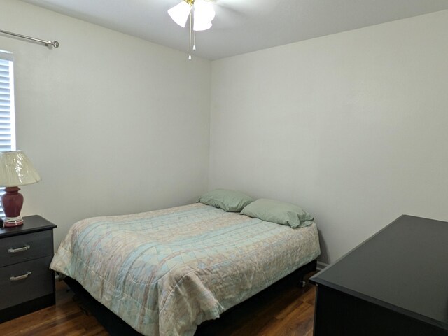 bedroom with dark wood-type flooring