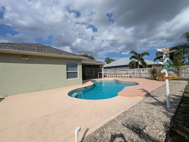 view of pool featuring a sunroom and a patio area