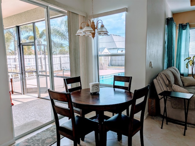 dining area featuring a notable chandelier