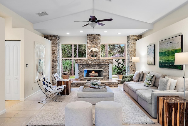 living room with ceiling fan, lofted ceiling, a fireplace, and light tile patterned floors