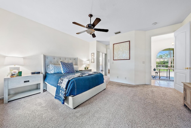 bedroom with light carpet and ceiling fan