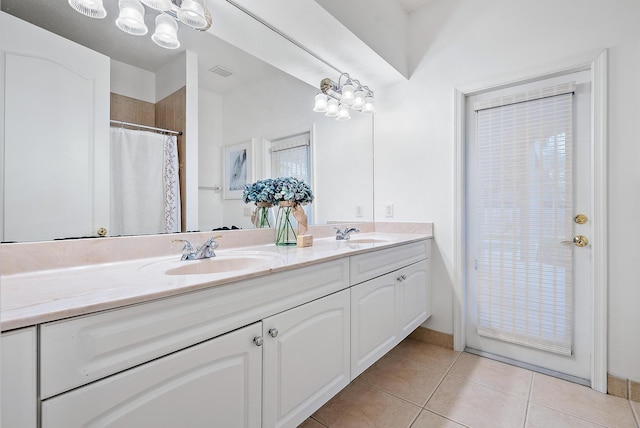 bathroom featuring a chandelier, vanity, and tile patterned flooring