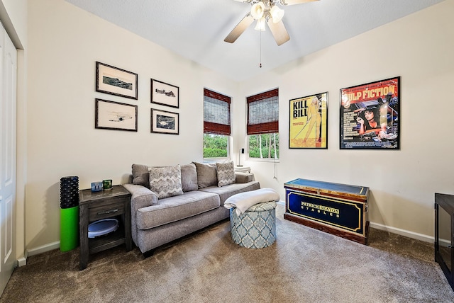 interior space with dark colored carpet and ceiling fan