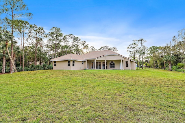 rear view of property featuring a yard