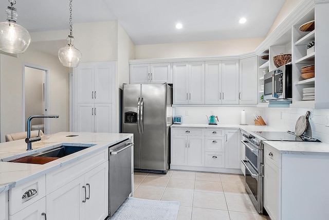 kitchen featuring sink, light stone countertops, decorative light fixtures, white cabinetry, and stainless steel appliances