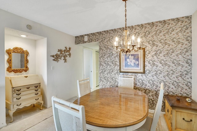 carpeted dining space featuring a chandelier