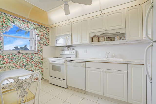 kitchen featuring ceiling fan, sink, light tile patterned flooring, white appliances, and white cabinets