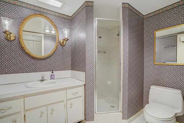 bathroom featuring vanity, toilet, and walk in shower