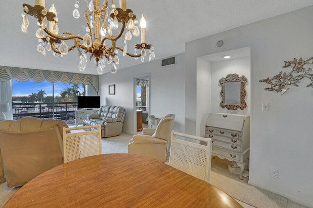 carpeted dining area featuring a notable chandelier