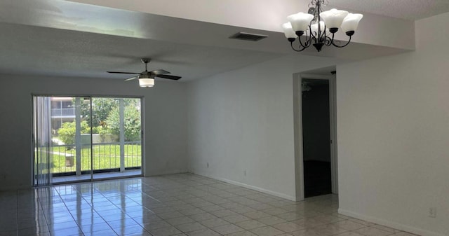 empty room with a textured ceiling, light tile patterned flooring, and ceiling fan with notable chandelier