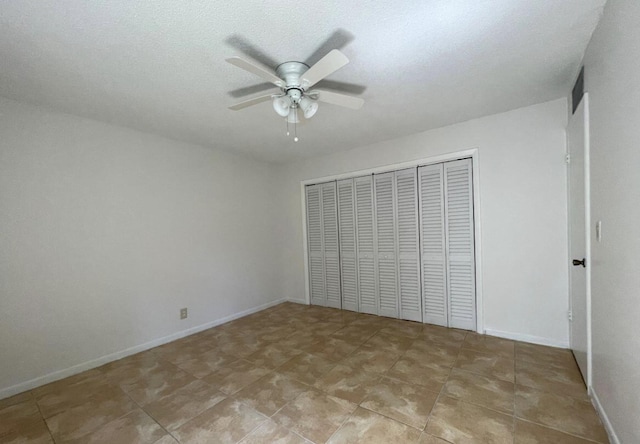 unfurnished bedroom featuring a closet and ceiling fan