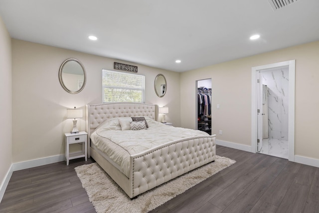 bedroom featuring a walk in closet, ensuite bathroom, a closet, and dark hardwood / wood-style floors