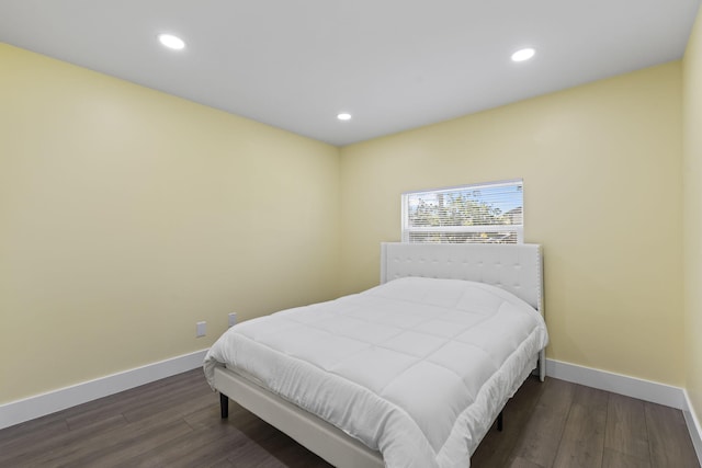 bedroom with dark wood-type flooring