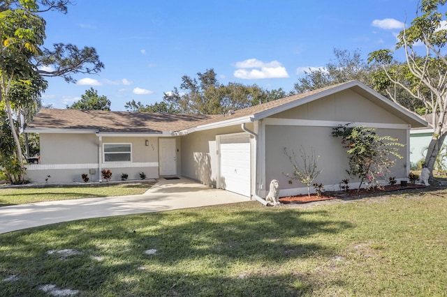 single story home with a front yard, concrete driveway, an attached garage, and stucco siding